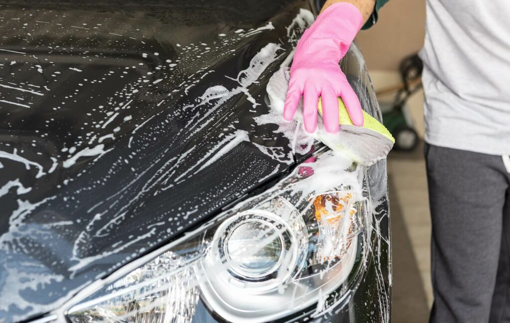 washing car with soapy cloth
