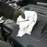 mechanic checking car engine oil