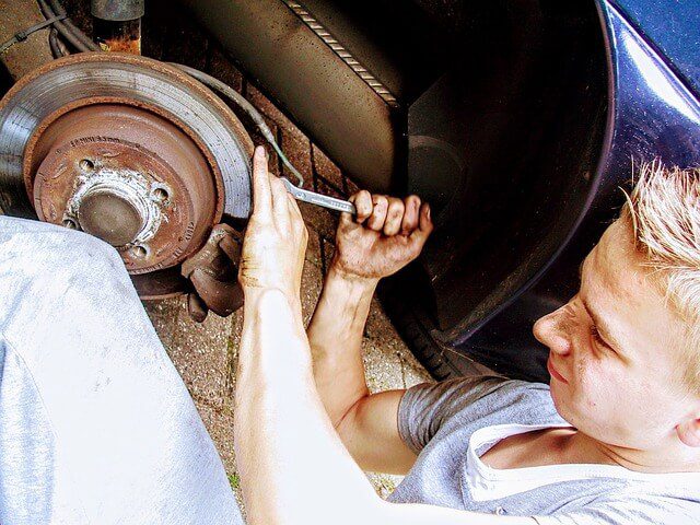 car mechanic fixing squeaky brakes